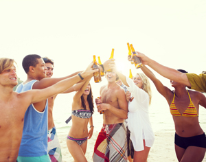 students at the beach drinking 