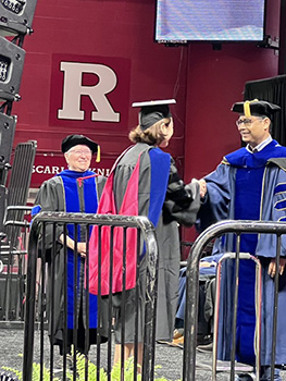 Associate Professor Vivek Singh hooding Katie Part at her SC&I graduation 