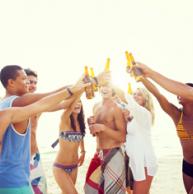 students at the beach drinking 